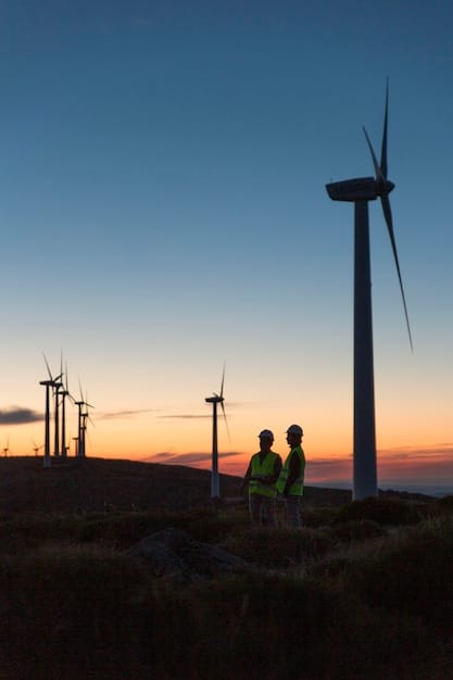 A group of engineers inspecting a wind turbine at sunset, showing the technical aspects of renewable energy infrastructure.
