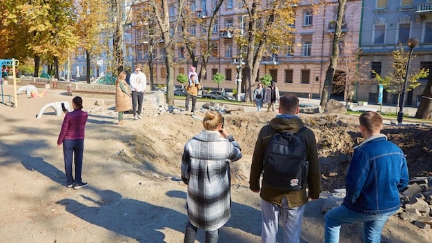 A photo of a community revitalization project, showing renovated homes and public spaces. People are seen interacting and enjoying the improved environment.