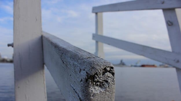 Close-up shot of a cracked section of concrete on a bridge support, highlighting the wear and tear and need for repair. This detailed image emphasizes the aging infrastructure and potential safety concerns.