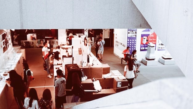 A busy exhibition hall at an anime convention, filled with attendees browsing merchandise booths. The booths showcase a wide array of products, from figurines and apparel to manga and artwork, creating a vibrant and bustling marketplace.