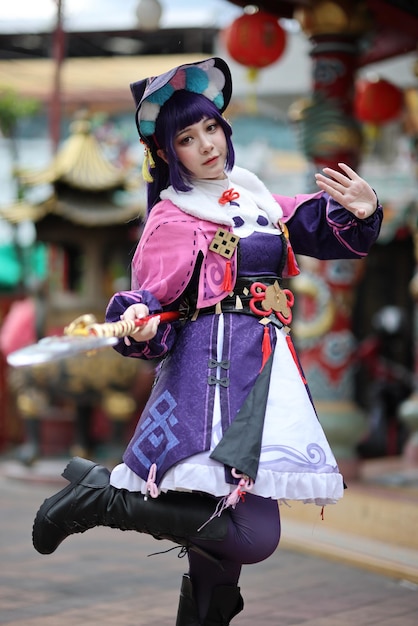 A photograph of an American cosplayer dressed as a popular anime character. The cosplayer is wearing a detailed and accurate costume, complete with a wig, makeup, and props. The cosplayer is posing dramatically at an anime convention, surrounded by other cosplayers and fans. The photograph captures the energy and excitement of the event.