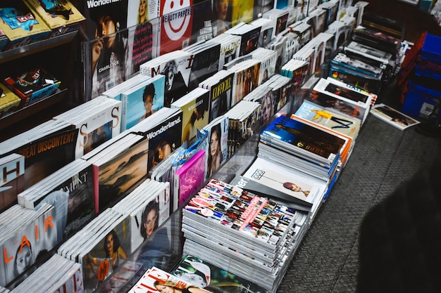 A vinyl record collection featuring classic rock albums, showcasing iconic album covers from bands like Led Zeppelin, The Rolling Stones, and Pink Floyd. The records are neatly arranged in a wooden crate with a vintage record player in the background.