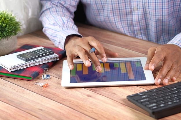 A person using a budgeting app on their smartphone. The screen displays colorful charts and graphs showing different expense categories. The person is sitting at a desk with a calculator and some papers, indicating they are actively managing their finances.